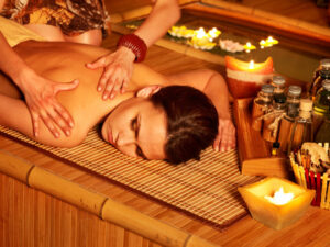 Woman getting massage in bamboo spa